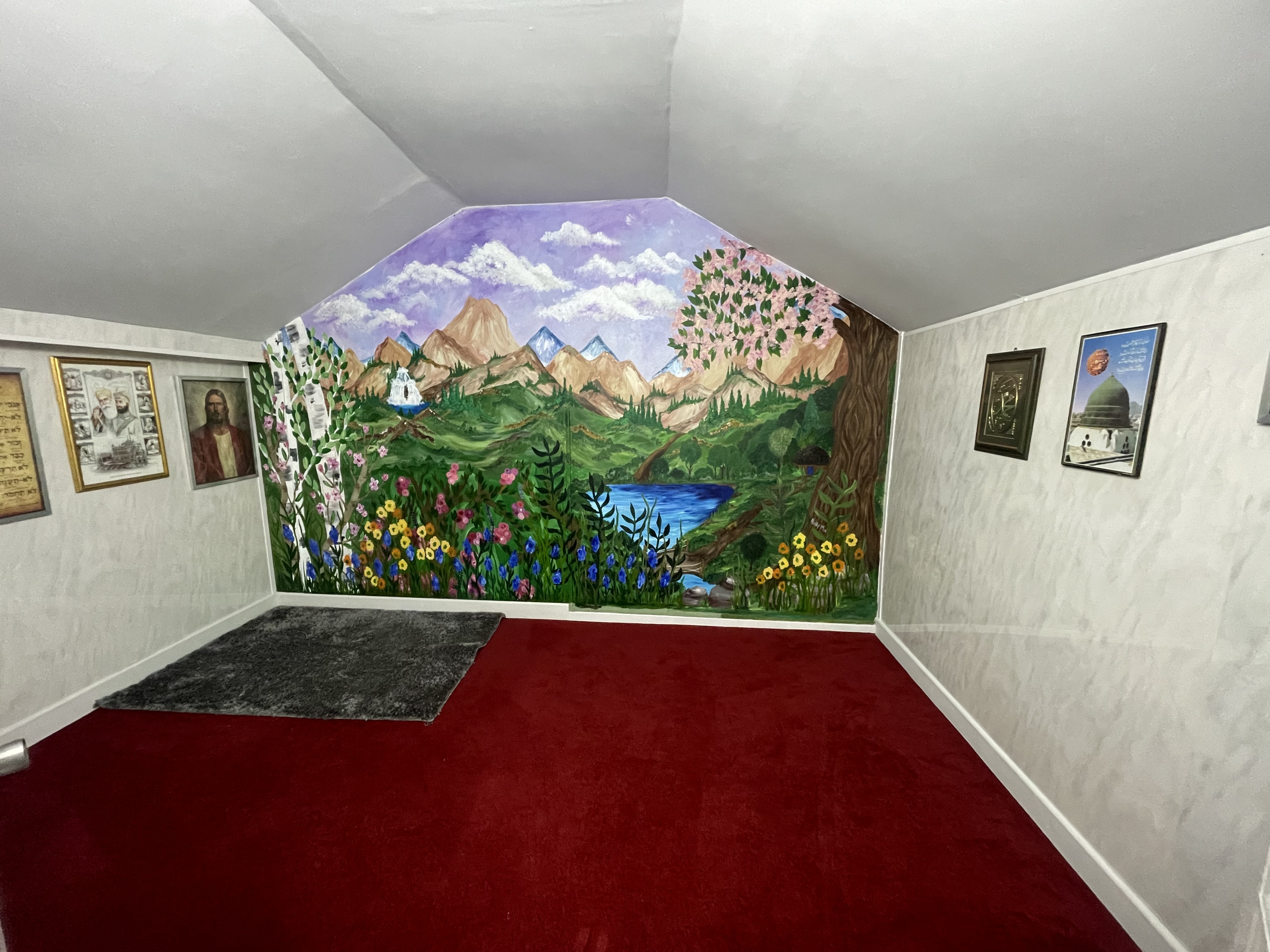 The prayer and reflection room at the Community Hub, with a painted landscape mural