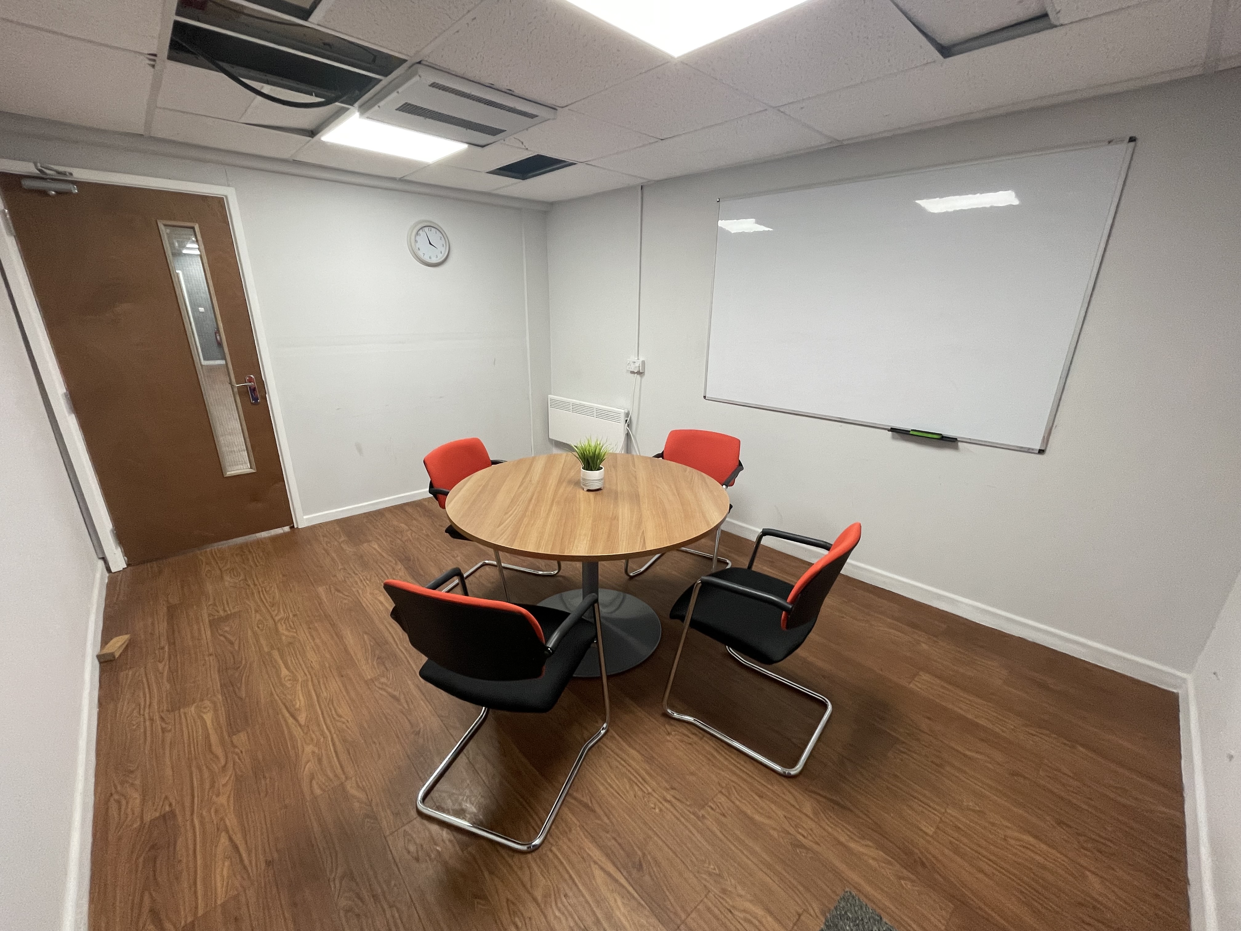 The Back Room at the Community Hub, a plain meeting room with a desk